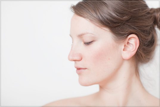 Ashley, massage therapist, shoulders on white, studio portrait by Mat Smith Photography, London