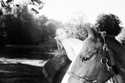 Rosy with a horse by a sunlit lake, polo calendar portrait by Mat Smith Photography
