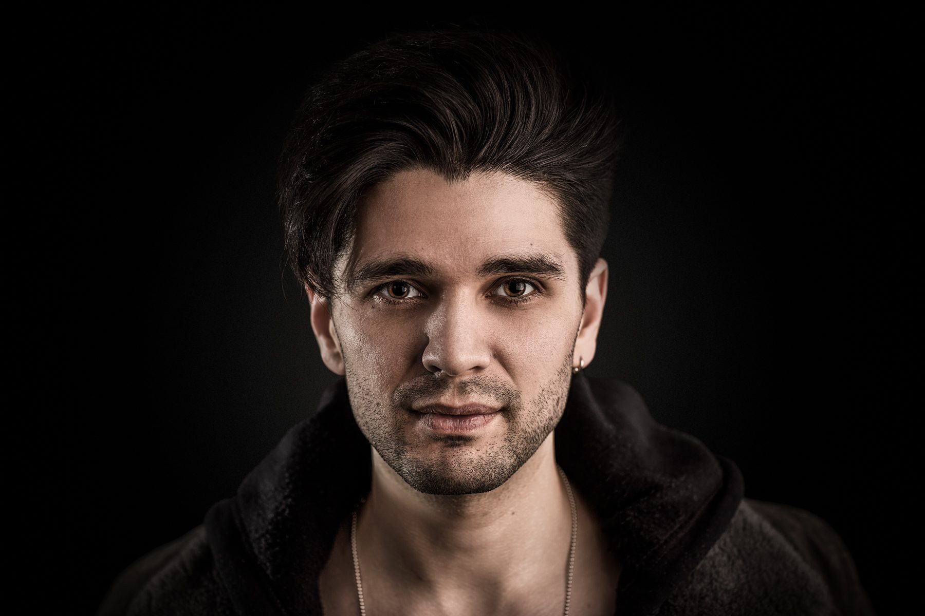 Sam Dixon of Maddox Magic, magician, studio headshot on black by Mat Smith Photography, Chiswick