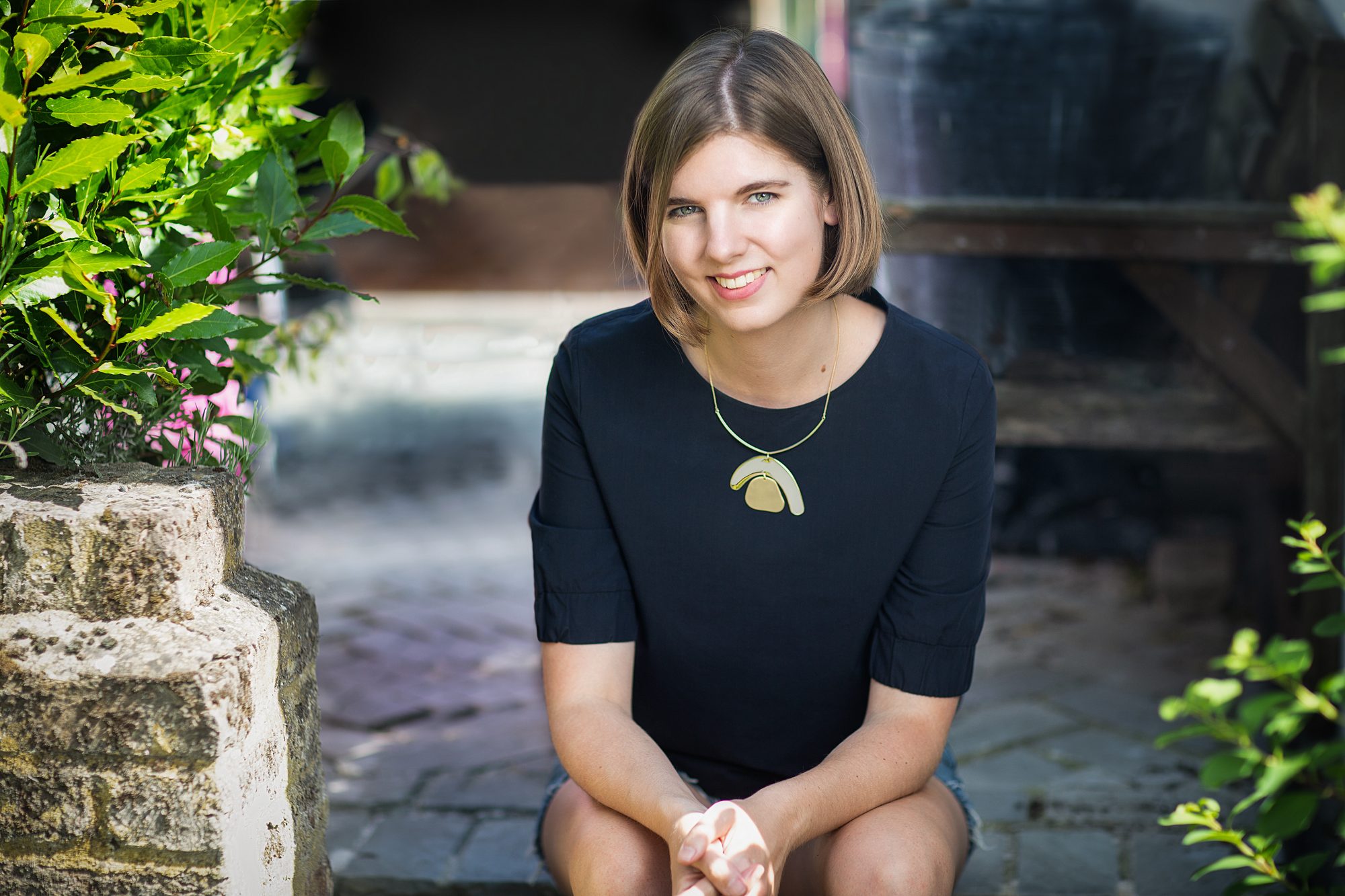 Elizabeth MacNeal, author and potter, on garden steps, portrait by Mat Smith Photography, East London