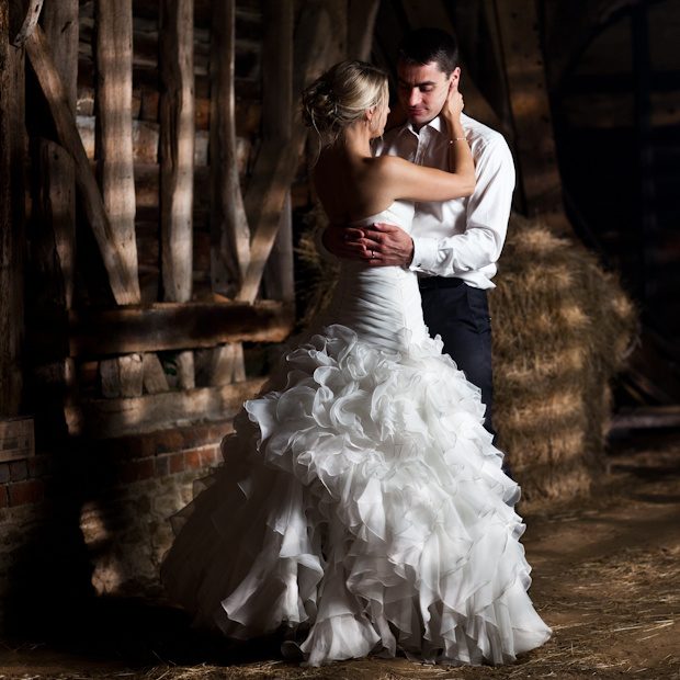 Rebecca and Edwin, late night portrait by Mat Smith Photography in Nurscombe Barn lit through the slats, Surrey