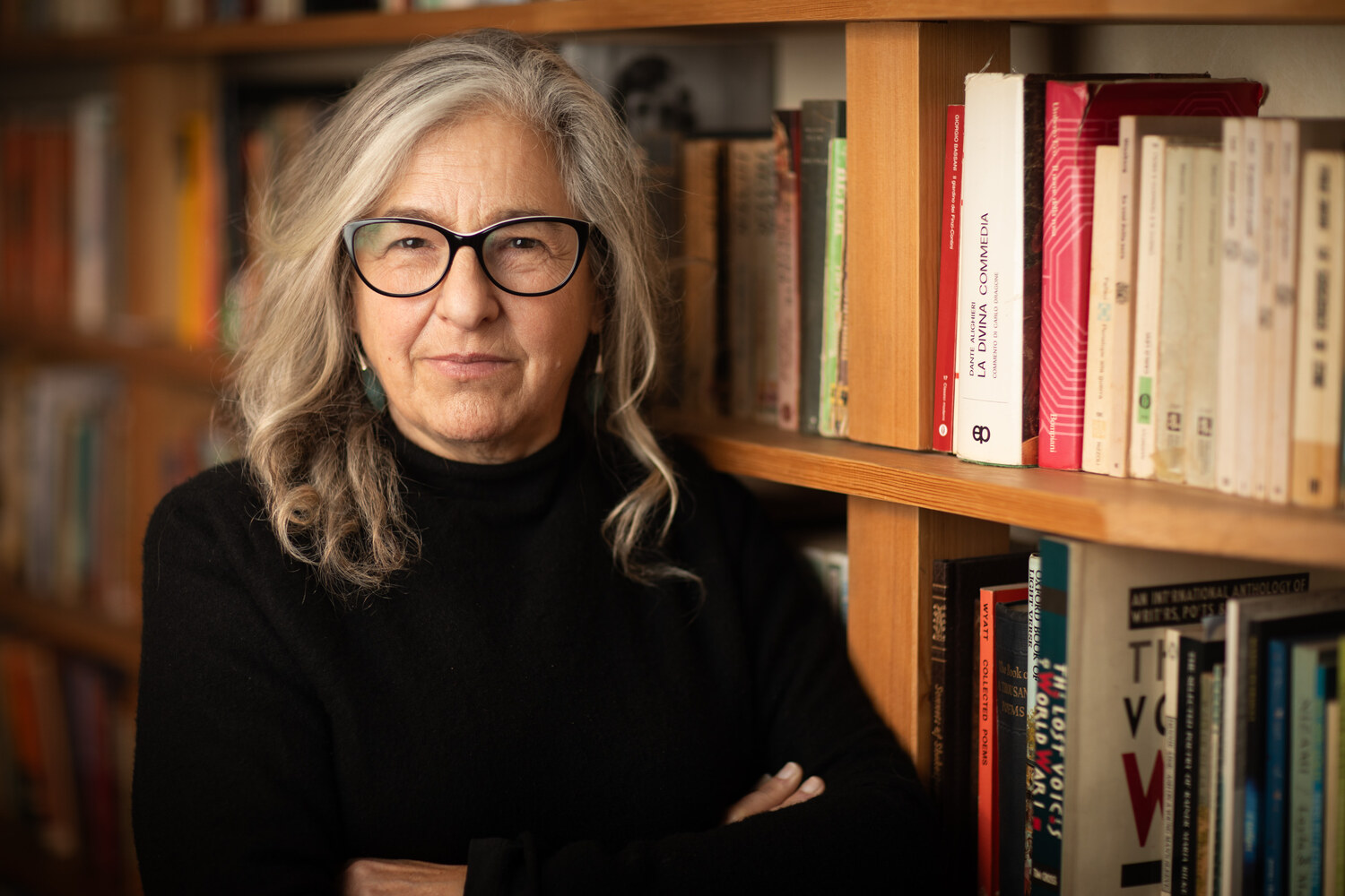 Karen Liebreich, author and historian, arms folded in front of her bookshelves