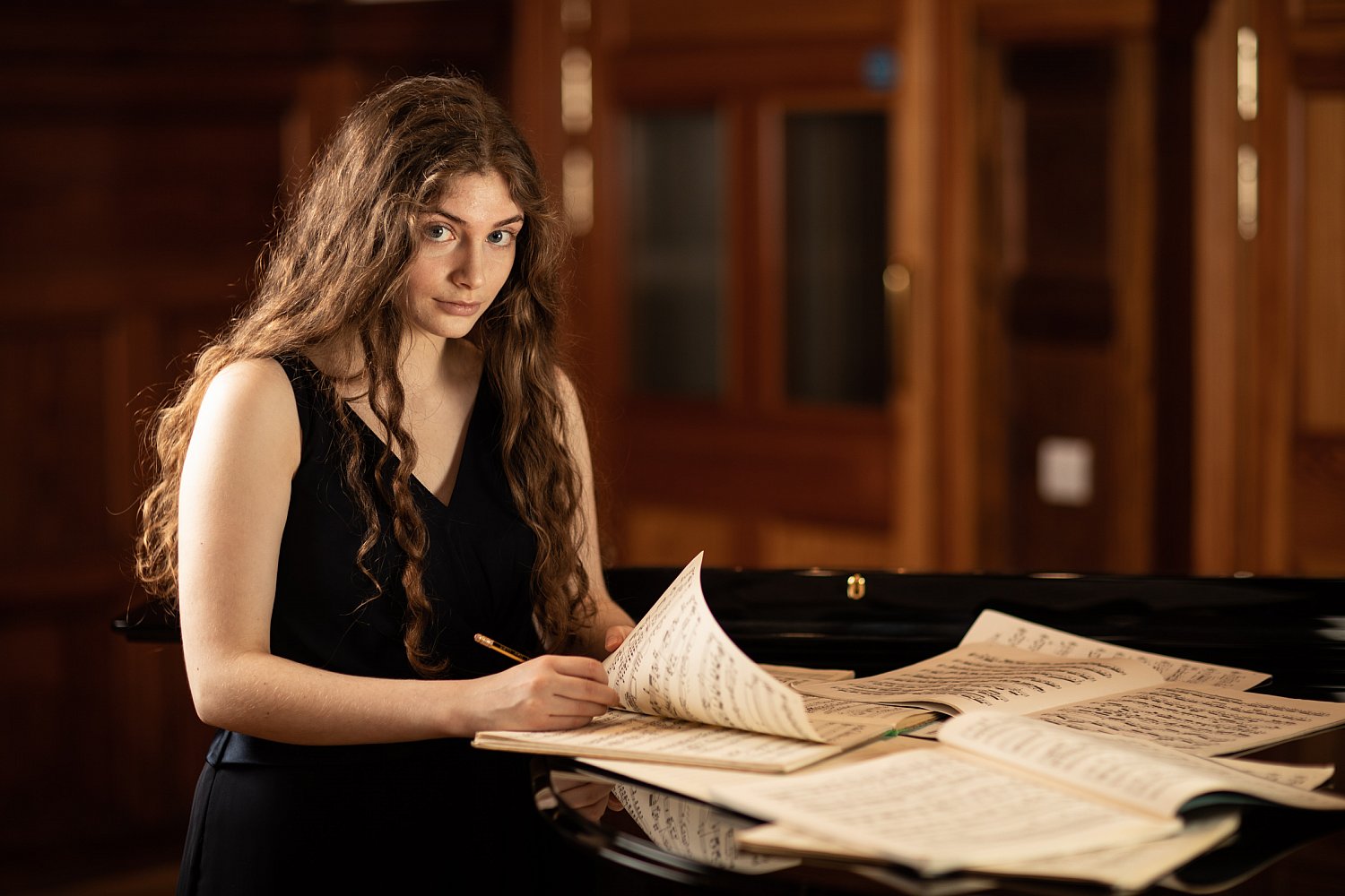 Musician annotating sheet music in rehearsal at the Royal College of Music