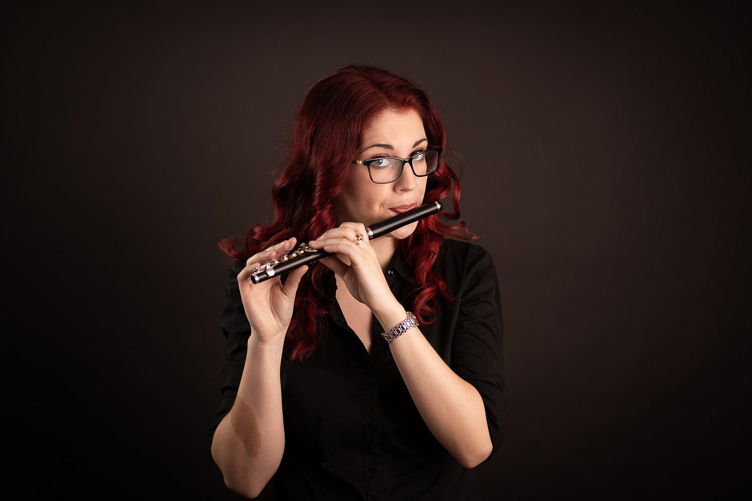 Red-haired flautist with a piccolo