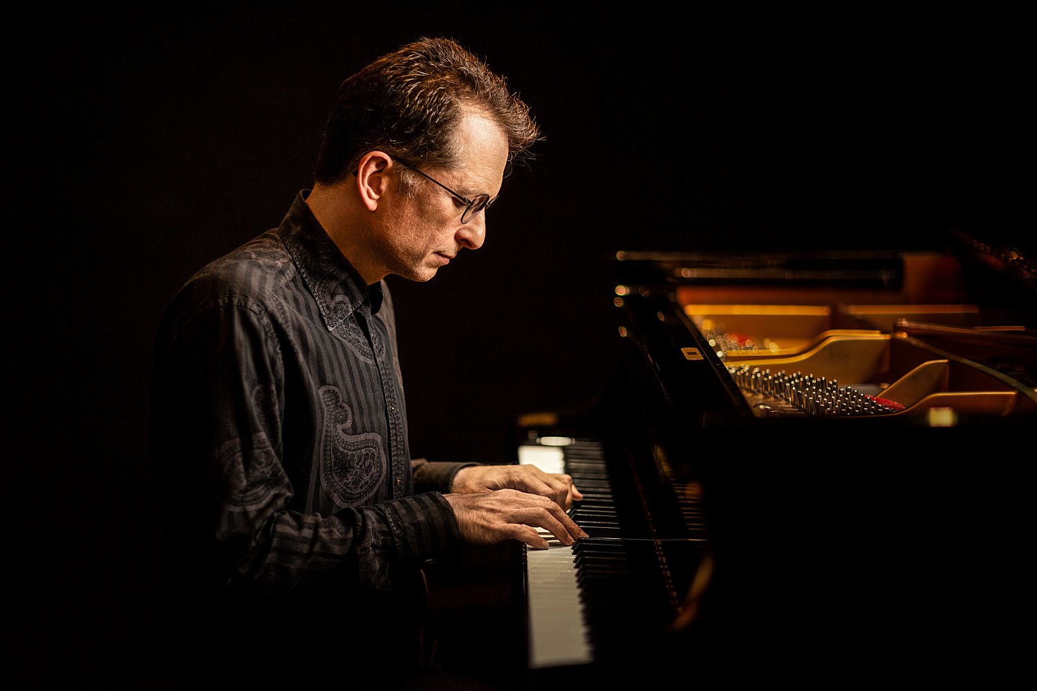 Pianist and composer playing in a recording studio